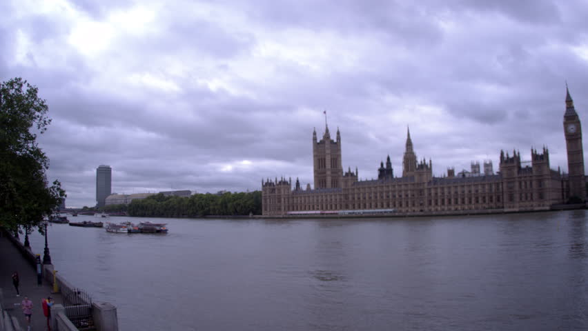 LONDON - OCTOBER 11: Pan across Westminster palace to unidentified people on