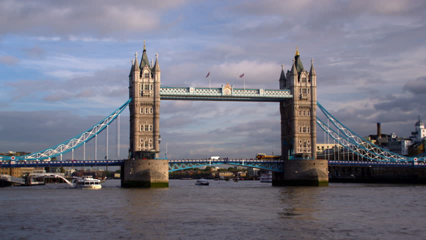 Large boat passes under Tower Bridge in London, England