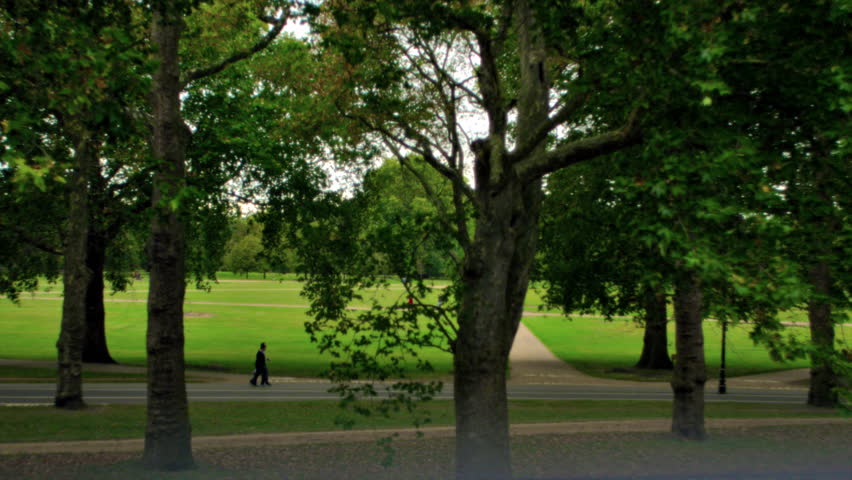 People walk through Hyde Park in London, England