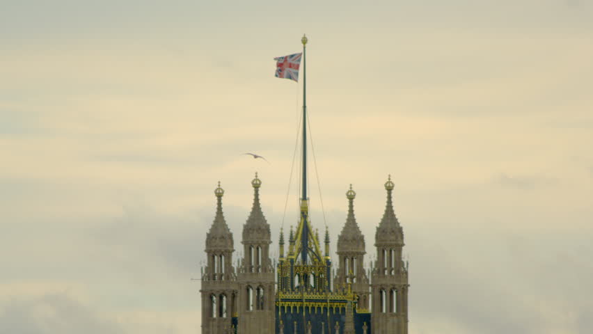 close-up of waving flag on top of Westminster Abbey in London