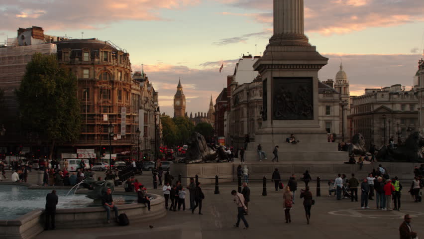 LONDON, UK - OCTOBER 7, 2011: Base of Nelson's Column with Big Ben in the