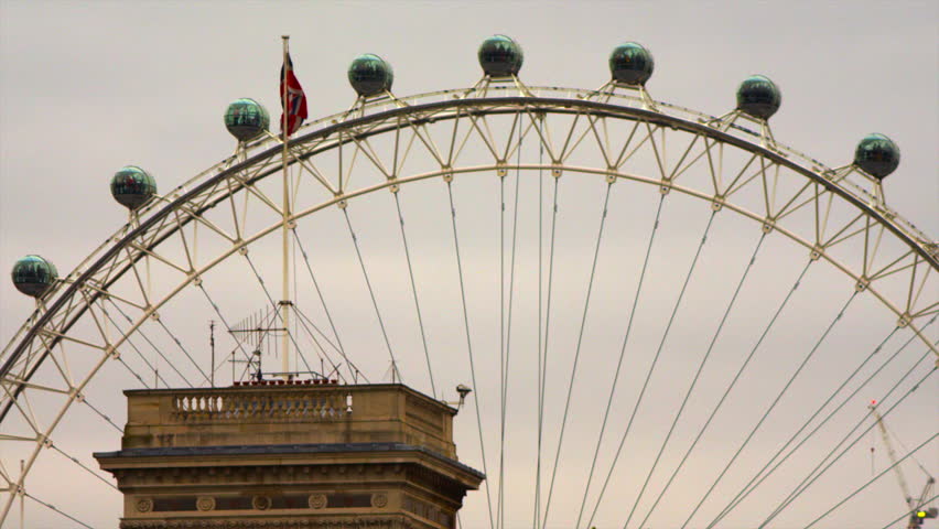 LONDON, UK - OCTOBER 8, 2011: British flag waving nearby London Eye.