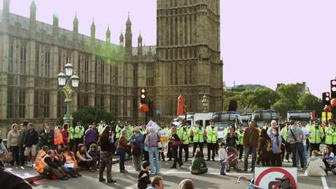 LONDON, UK - OCTOBER 9, 2011: Protesters and unidentified policemen near Big Ben.