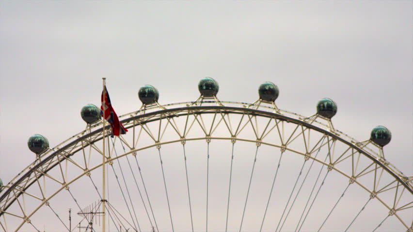 LONDON, UK - OCTOBER 8, 2011: British flag and London Eye capsules.