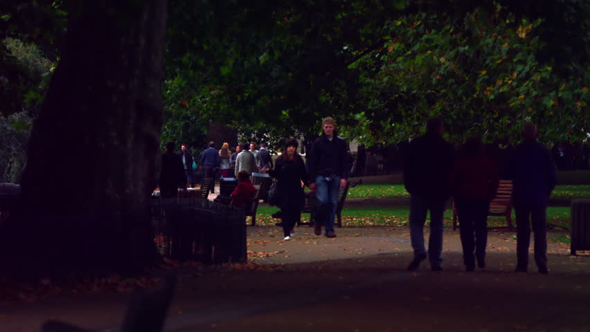 LONDON, UK - OCTOBER 8, 2011: People and a squirrel on a park road.