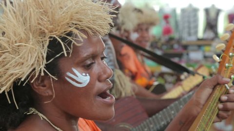 NOUMEA, GRANDE TERRE/NEW CALEDONIA - FEBRUARY 06, 2014: Unidentified Kanak people of Noumea, New Caledonia playing music for tourists