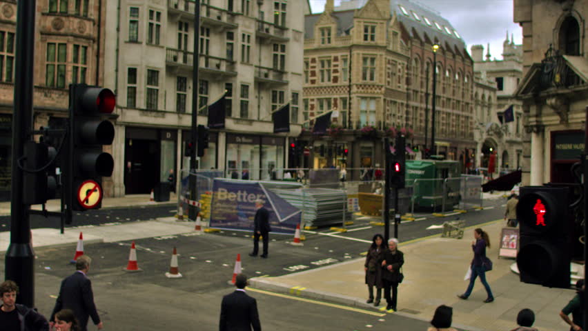 LONDON, UK - OCTOBER 11, 2011: Traveling shot of pedestrians alongside busy