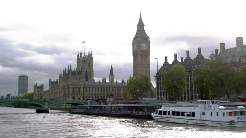 LONDON, UK - OCTOBER 11, 2011: Birds fly over water with Westminster palace in