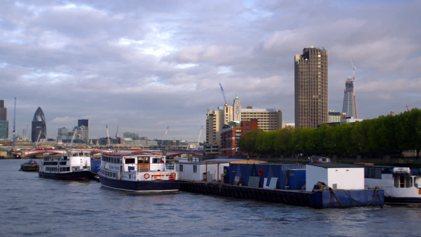 LONDON, UK - OCTOBER 11, 2011: Boats on River Thames with buildings in