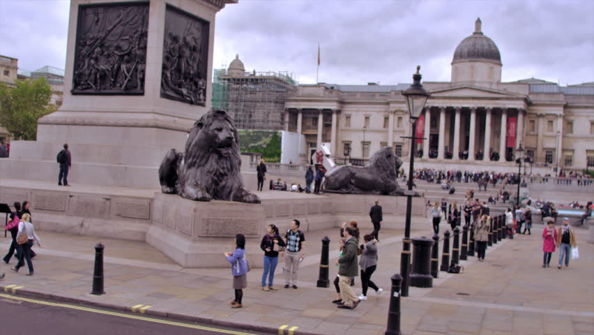 LONDON, UK - OCTOBER 11, 2011: people near the Brass Lions in Trafalgar Square.