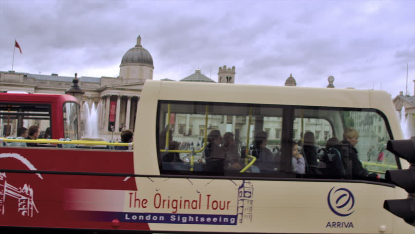 LONDON, UK - OCTOBER 11, 2011: people walk around Trafalgar Square, red bus