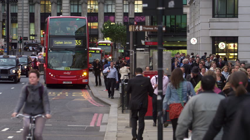 LONDON, UK - OCTOBER 10, 2011: Double-decker bus stopping on a busy street
