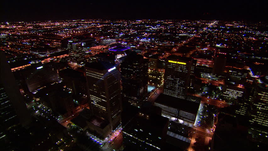 Overview Phoenix Arizona. Far view of the US Airways Center in Phoenix, Arizona. Features bright purple lights, lens flares, beautiful cityscape scenery and a view of the Wells Fargo building.