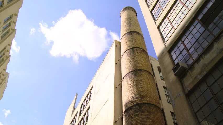 NEW YORK - CIRCA MARCH 2013: Low angle view of a smokestack on the side of a building in New York City on a sunny day.