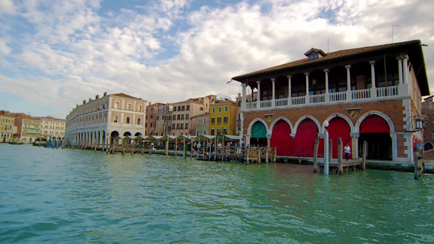 Passing by Venetian canal side buildings on a water taxi