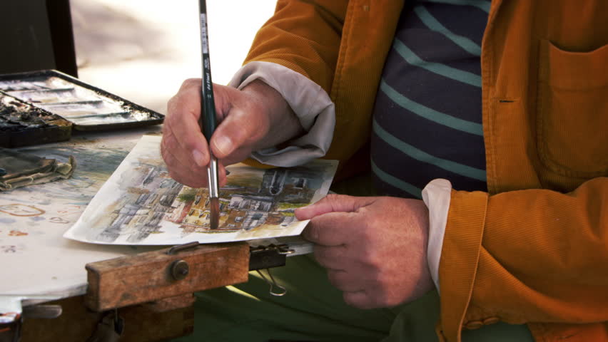 Shot of artist painting using watercolors a scene in Venice