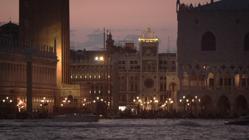 Static shot of boat passing in front of Piazza San Marco and the Doge's palace,
