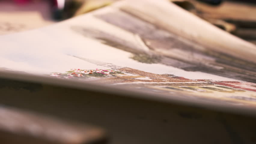 Shot of an artist painting in details in a watercolor painting