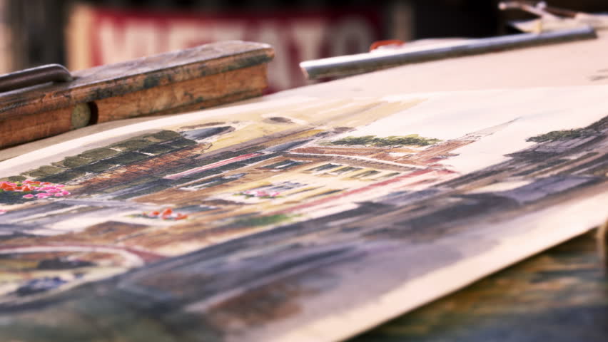 Close up shot of artist painting in details in a watercolor painting