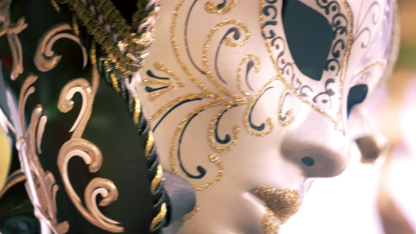 Close up shot of a carnival mask blowing in the wind