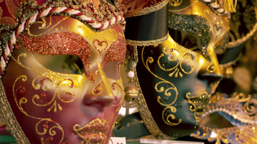 Tight static shot of several carnival masks