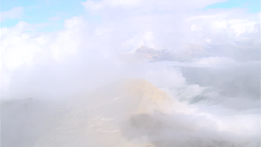 Snow on Mountaintops. Clouds cover a snow-covered mountain range.