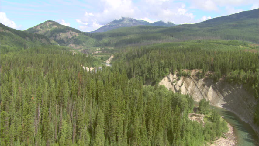 River Running Through Beautiful Valley. River flowing through a beautiful green valley.