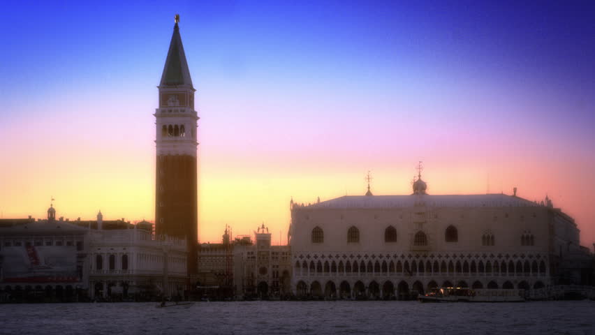 Slow motion shot of the setting sun sky behind Doge's Palace and Marco Tower