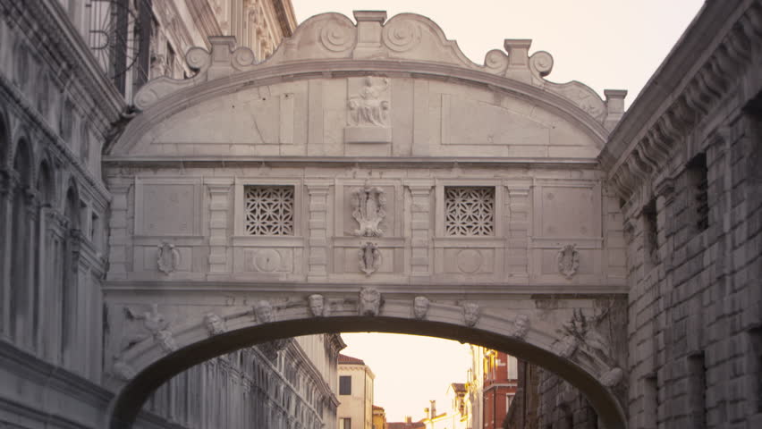 Tilt shot of the Bridge of Sighs and the canal beneath it