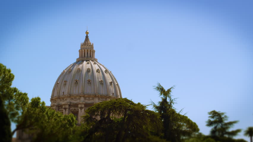 Shot of the Vatican dome from a distance looking through trees