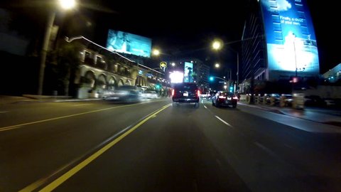 WEST HOLLYWOOD, CA: February 27, 2014- POV of driving at night on the famous Sunset Boulevard on the Sunset Strip circa 2014 in West Hollywood. This is a 30 second time lapse clip covering the strip.