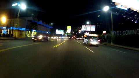 WEST HOLLYWOOD, CA: February 27, 2014- POV driving shot at night on Sunset Boulevard circa 2014 in West Hollywood. View of the Sunset Strip as it passes the Chateau Marmont Hotel.