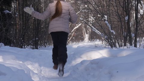 girl plays in the winter woods