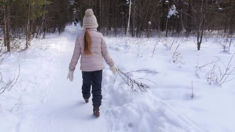 girl plays in the winter woods
