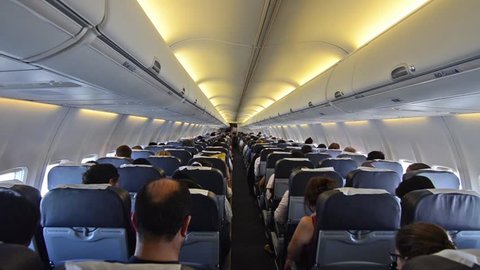 Interior of airplane with passengers on seats