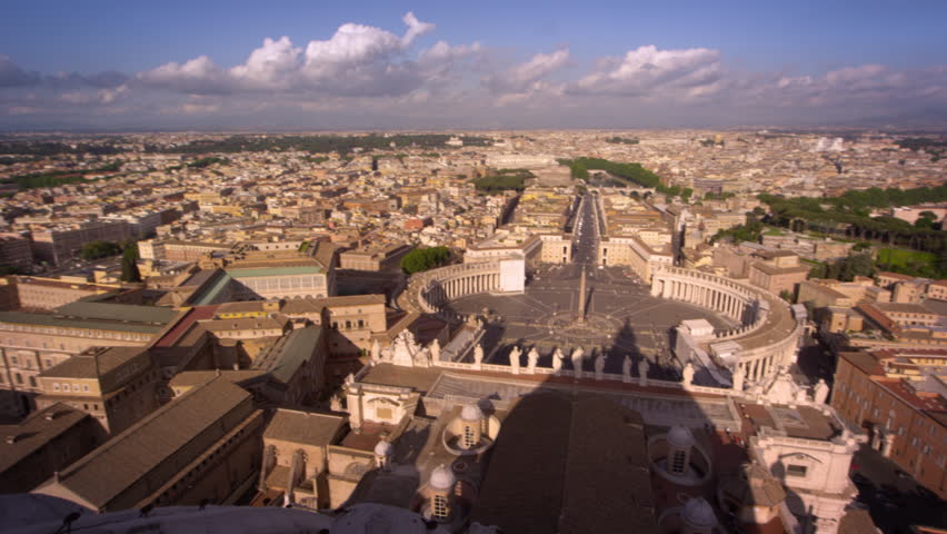 Aerial pan of St Peter's plaza and the rooftops of Rome