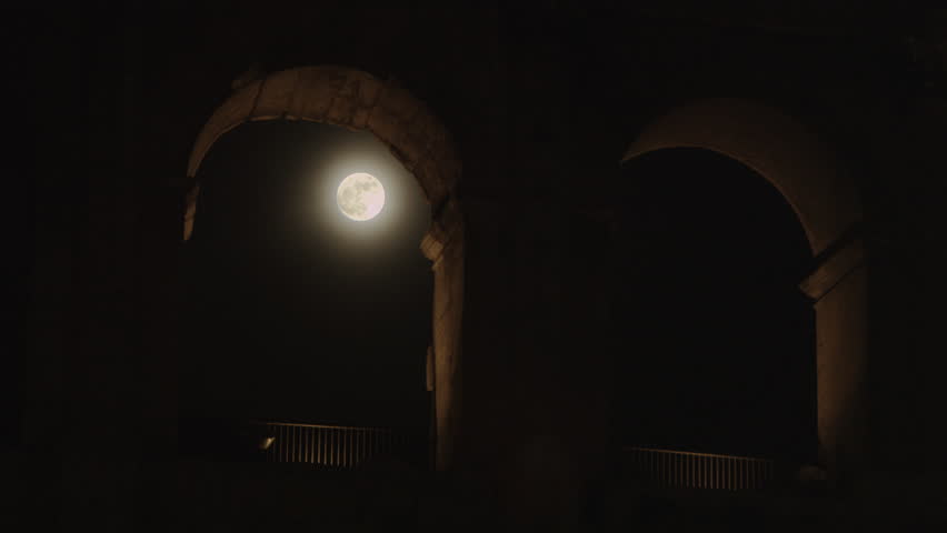 Full moon through arch at night