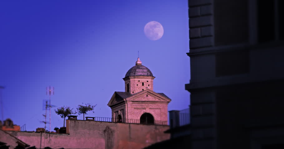 Moon behind small domed building