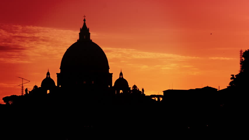 St Peter's Basilica silhouetted against a sunset