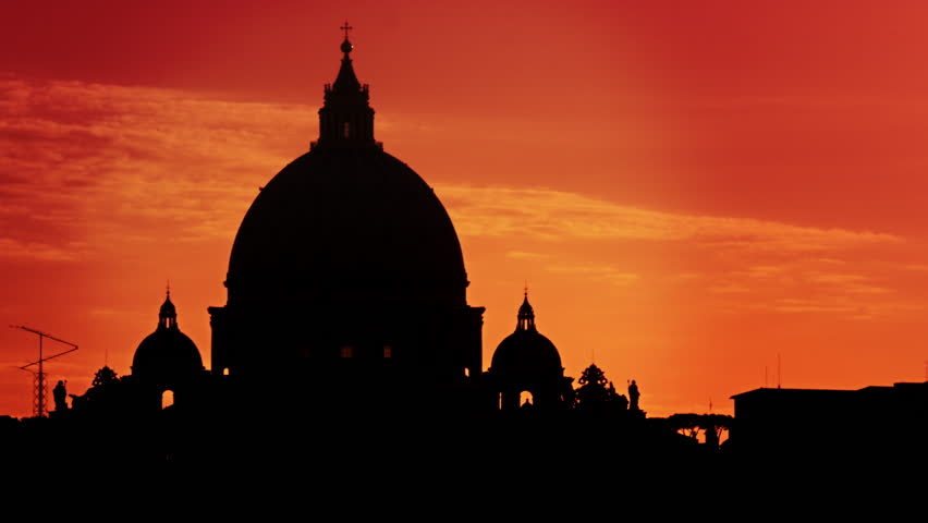 Close up of St Peter's Basilica silhouetted against a sunset