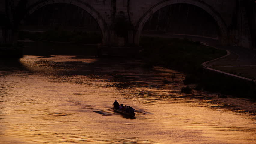 Footage of rowing boat underneath bridge on the Tiber River