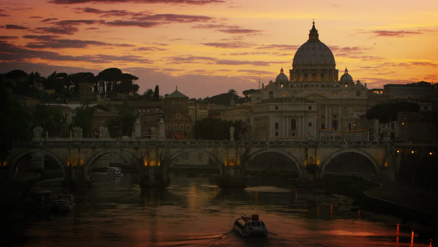 A boat travels under the Ponte Sant Angelo at dusk Dome of St Peters Basilica in