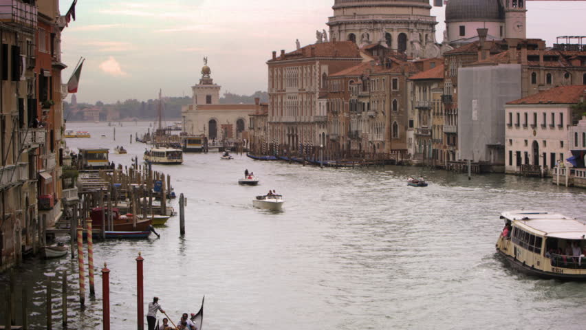 VENICE, ITALY - MAY 2, 2012: Boats and gondolas on a canal near Santa Maria