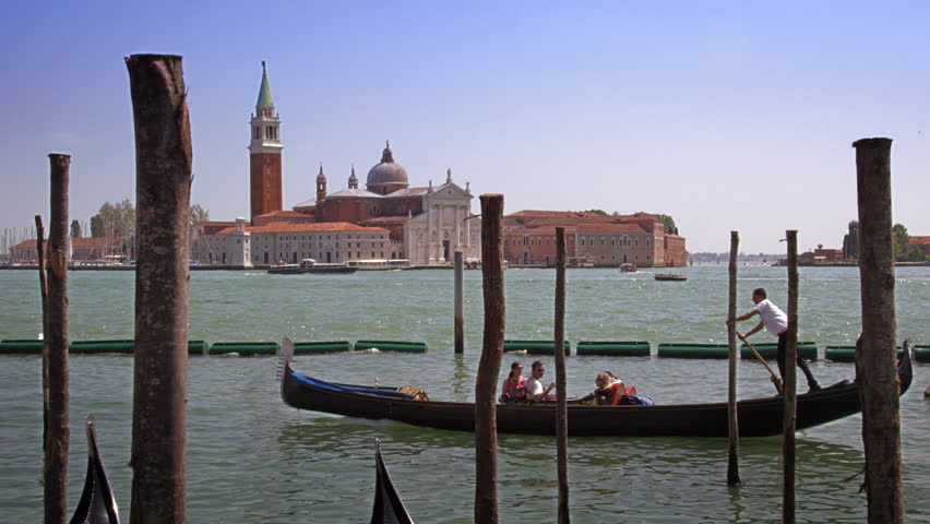 VENICE, ITALY - MAY 2, 2012: Slow motion shot of passing gondolas in docking bay