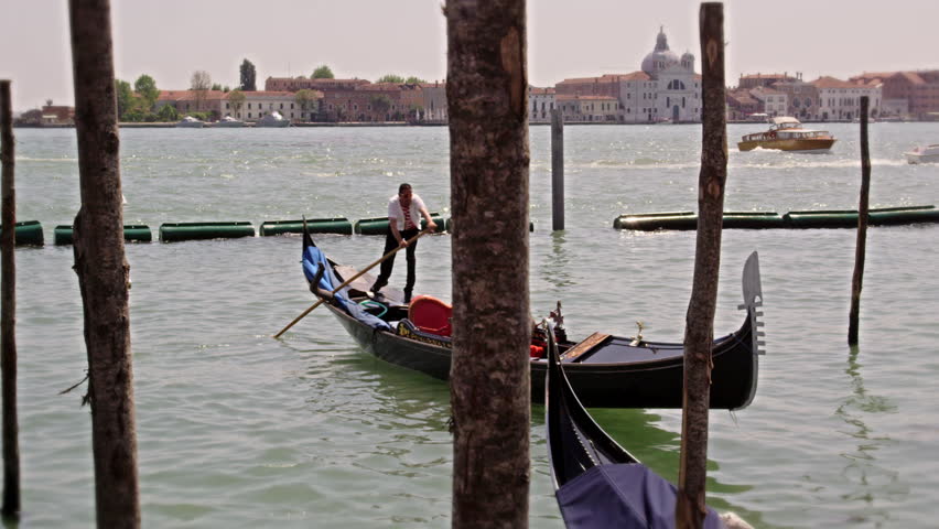 VENICE, ITALY - MAY 2, 2012: Slow motion shot of a gondolier docking his boat