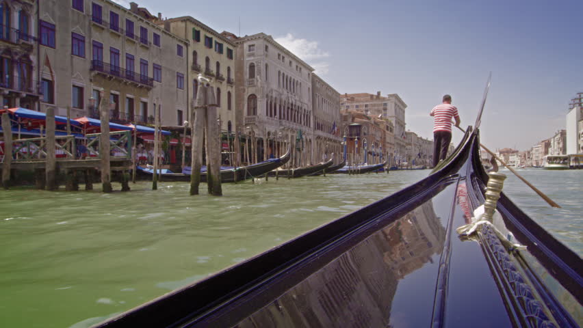 VENICE, ITALY - MAY 2, 2012: Gondola follows other gondola down the Grand Canal