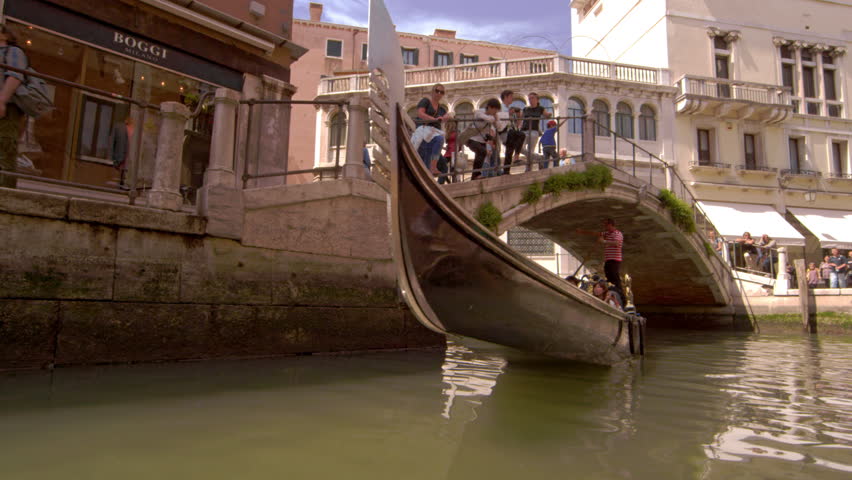 VENICE, ITALY - MAY 2, 2012: Tourists in a gondola in slow motion