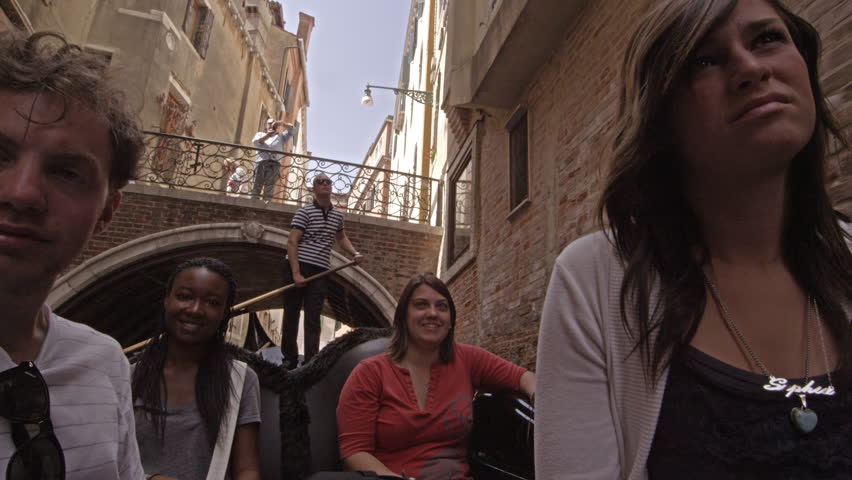 VENICE, ITALY - MAY 2, 2012: Rear-facing view in gondola facing toward people