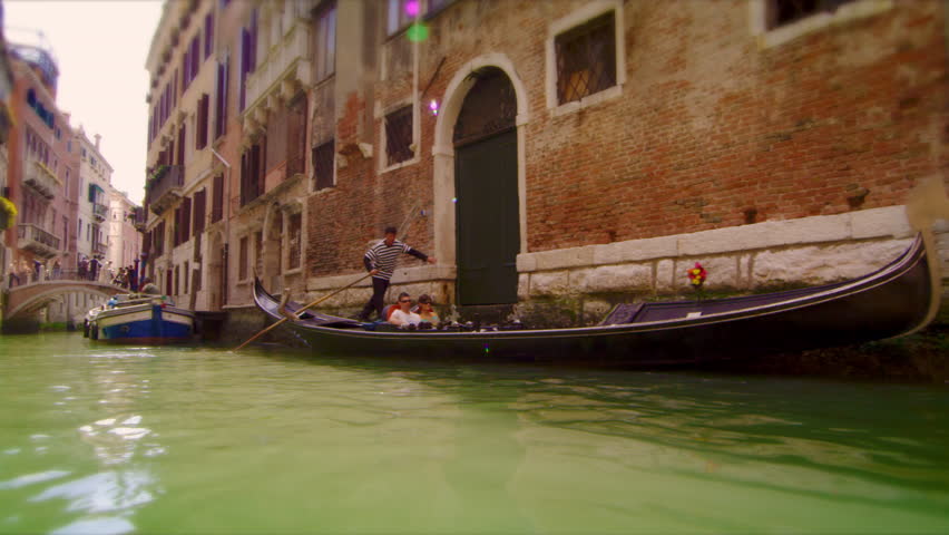 VENICE, ITALY - MAY 2, 2012: Slow motion tracking shot of canal intersection