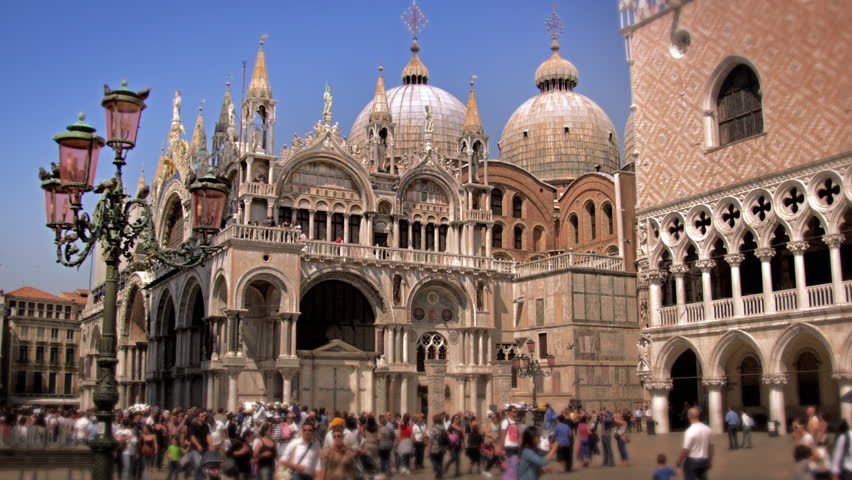 VENICE, ITALY - MAY 2, 2012: Shot of Basilica San Marco as people walk Piazza